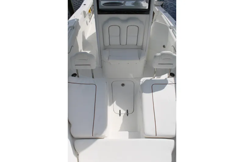 Slide: The Image of 2019 Sea Hunt Gamefish 25 boat interior with white seating and storage compartments. - 12