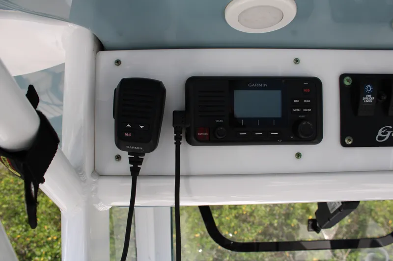 Slide: The Image of 2019 Sea Hunt Gamefish 25 boat dashboard with Garmin marine radio and controls. - 16