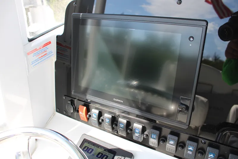 Slide: The Image of 2019 Sea Hunt Gamefish 25 dashboard with Garmin display and control switches. - 20