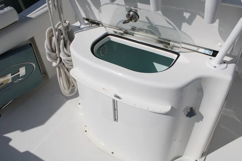 Slide: The Image of 2019 Sea Hunt Gamefish 25 boat with livewell and coiled rope on deck. - 33