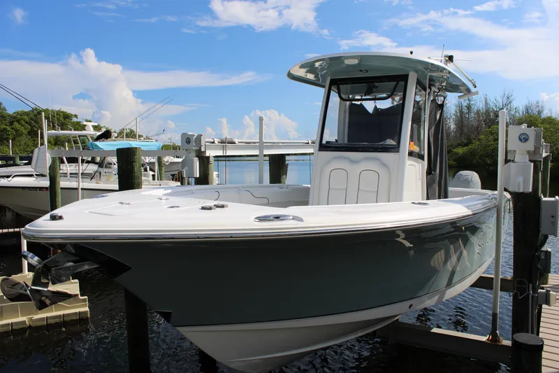 Slide: The Image of 2019 Sea Hunt Gamefish 25 boat docked at marina under clear blue sky. - 3