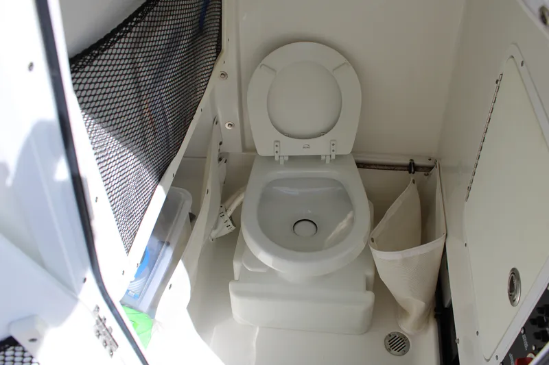 Slide: The Image of 2019 Sea Hunt Gamefish 25 boat interior with compact marine toilet. - 39