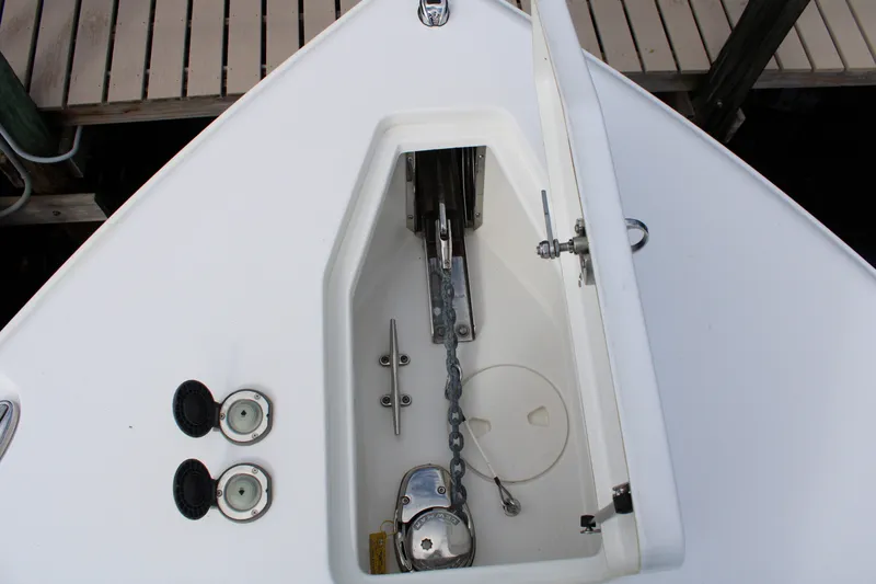 Slide: The Image of Anchor compartment of 2019 Sea Hunt Gamefish 25 boat, featuring chain and cleat. - 10