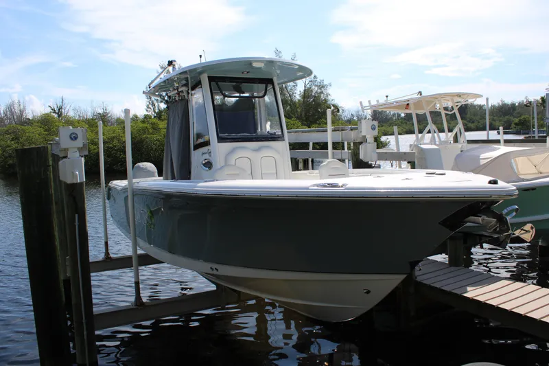 Slide: The Image of 2019 Sea Hunt Gamefish 25 boat docked on a sunny day. - 5