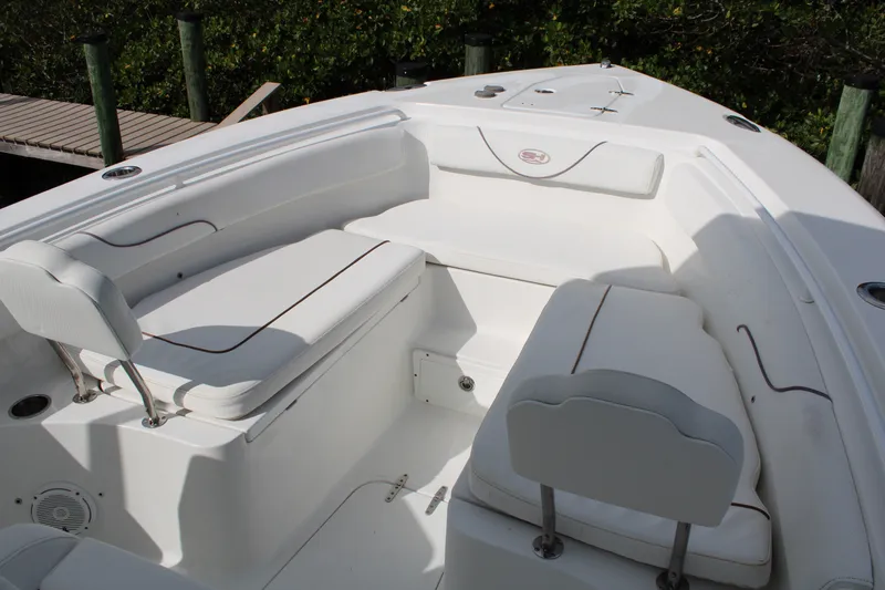 Slide: The Image of 2019 Sea Hunt Gamefish 25 boat interior with white cushioned seating. - 11