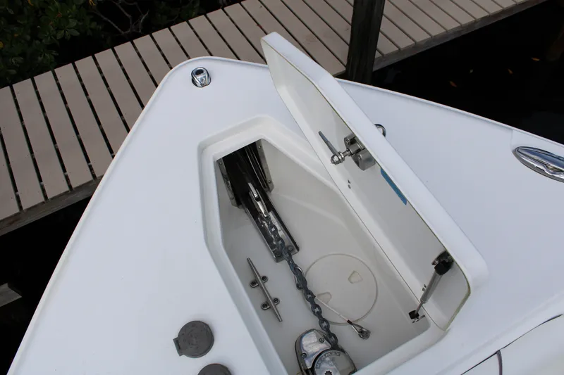 Slide: The Image of Open anchor compartment on 2019 Sea Hunt Gamefish 25 boat, showing chain and mechanism. - 8