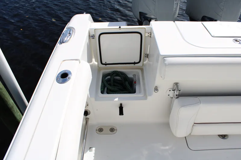 Slide: The Image of 2019 Sea Hunt Gamefish 25 boat deck with storage compartment and coiled rope. - 28