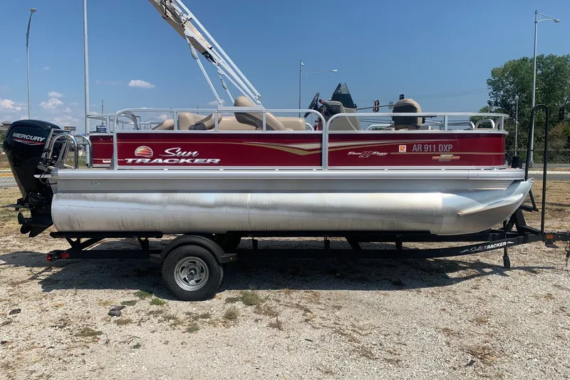 The Image of 2023 Sun Tracker Bass Buggy 18 DLX pontoon boat on trailer, side view. - 0