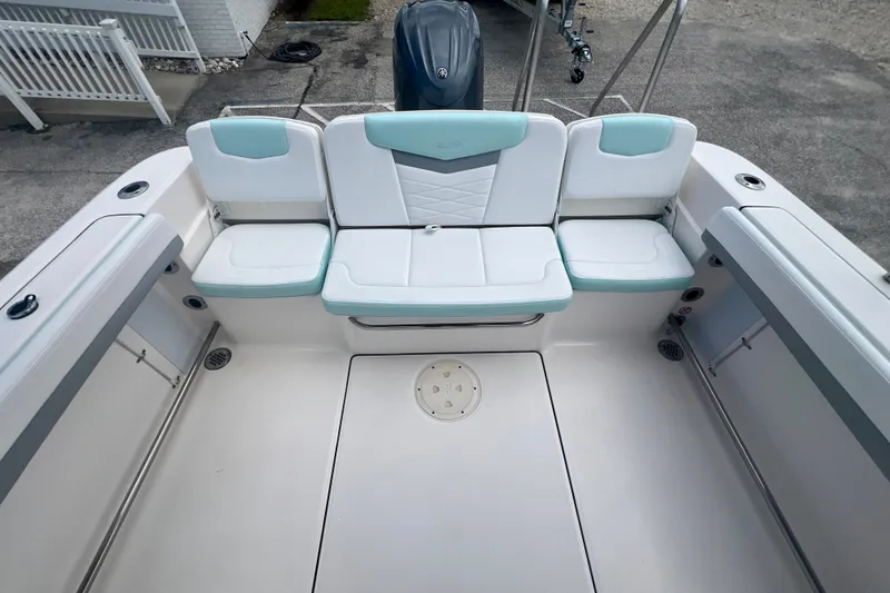 Slide: The Image of 2024 Robalo R207 Dual Console boat interior with cushioned seating and storage compartments. - 9