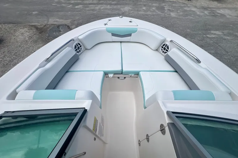 Slide: The Image of 2024 Robalo R207 Dual Console boat interior with cushioned seating and speakers. - 16
