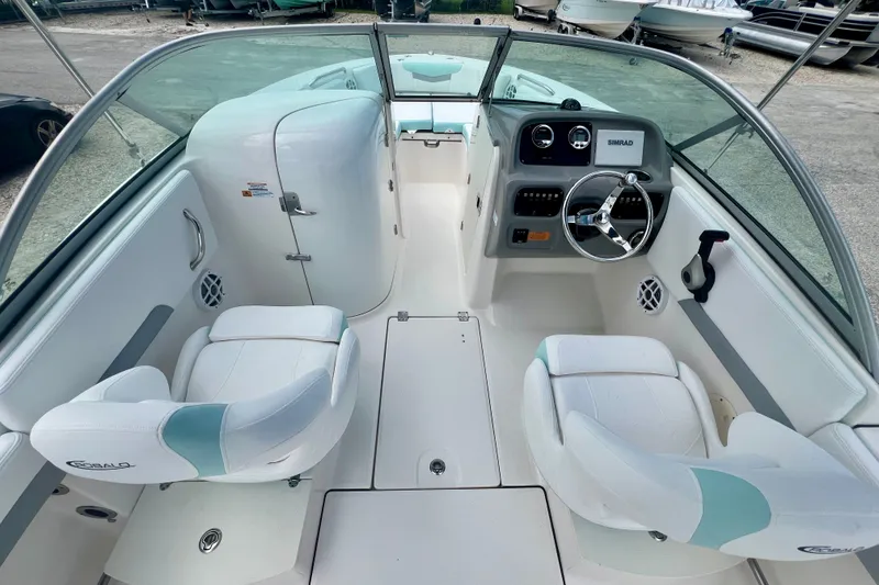 Slide: The Image of 2024 Robalo R207 Dual Console boat interior with steering wheel and seating. - 11