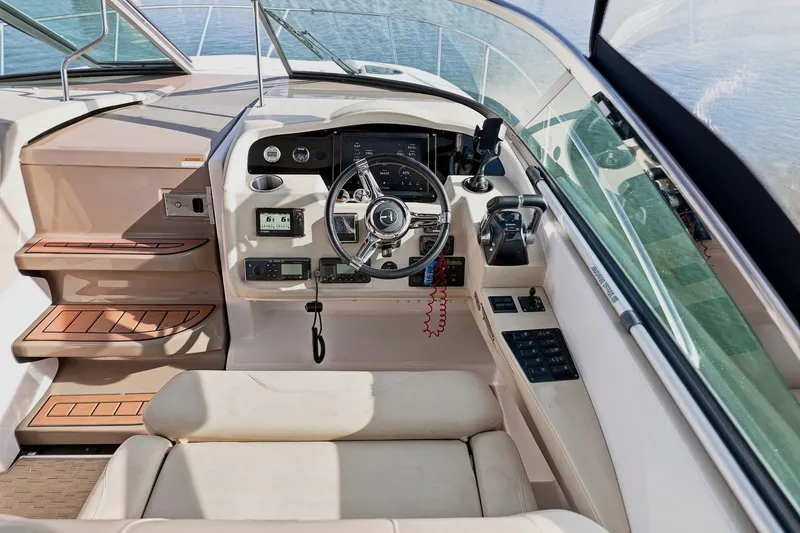 Slide: The Image of Cockpit of 2018 Regal 33 XO boat with modern controls and steering wheel. - 54