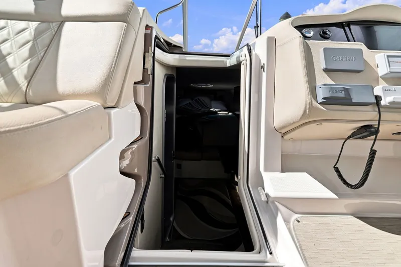 Slide: The Image of Interior view of 2018 Regal 33 XO boat, featuring seating and control panel. - 58