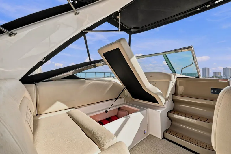 Slide: The Image of 2018 Regal 33 XO boat interior with open storage compartment and seating. - 52