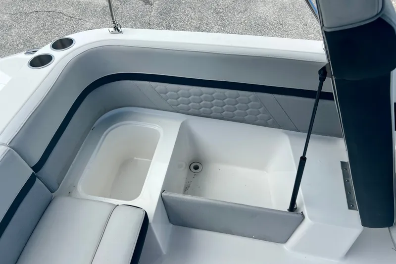 Slide: The Image of 2024 Hurricane Sundeck Sport 218 OB boat interior with seating and storage compartments. - 10