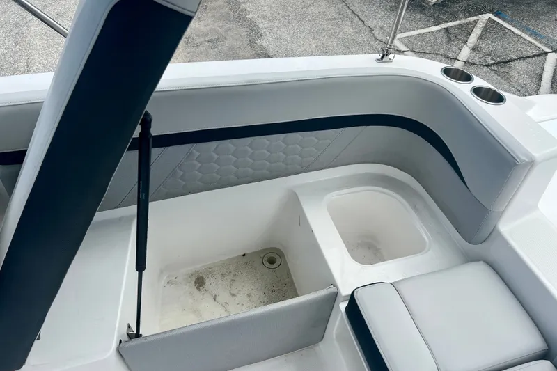 Slide: The Image of 2024 Hurricane Sundeck Sport 218 OB boat interior with seating and storage compartments. - 11