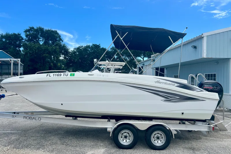 Slide: The Image of 2024 Hurricane Sundeck Sport 218 OB boat on trailer, parked outdoors. - 5