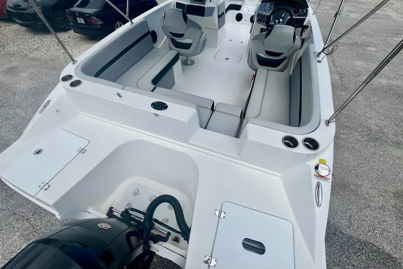 Slide: The Image of 2024 Hurricane Sundeck Sport 218 OB boat interior with seating and steering console. - 8