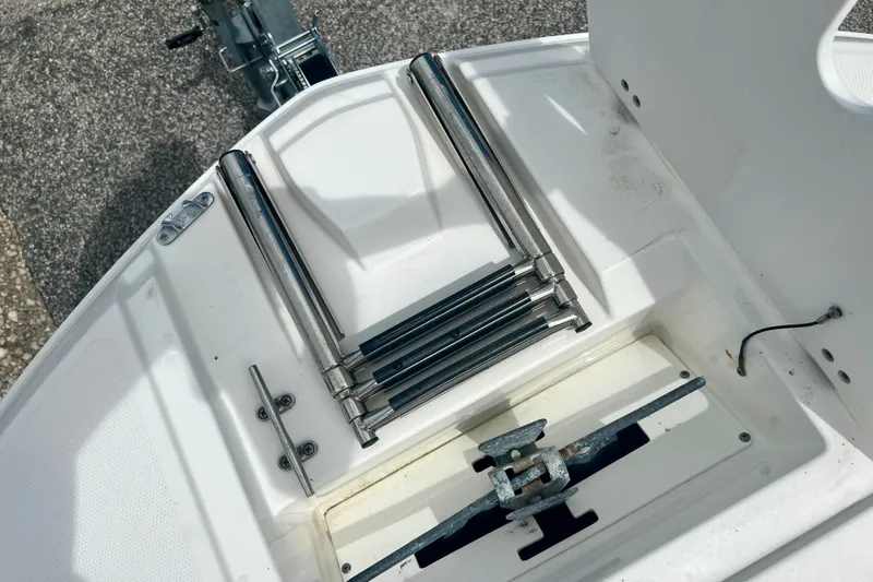 Slide: The Image of 2024 Hurricane Sundeck Sport 218 OB boat ladder and anchor storage area. - 19