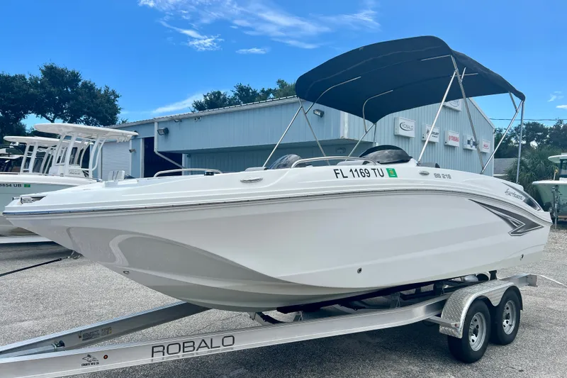 Slide: The Image of 2024 Hurricane Sundeck Sport 218 OB boat on trailer, outdoor dealership setting. - 4