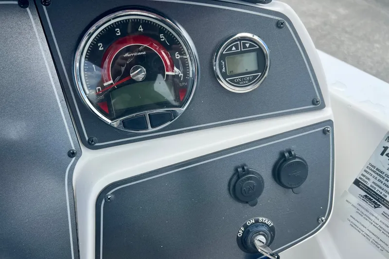 Slide: The Image of 2024 Hurricane Sundeck Sport 218 OB dashboard with gauges and ignition key. - 15