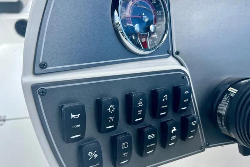Slide: The Image of Control panel of 2024 Hurricane Sundeck Sport 218 OB boat with switches and speedometer. - 14