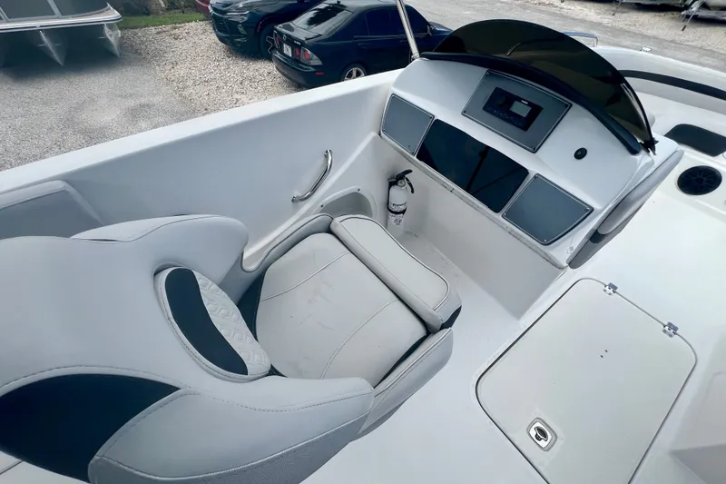 Slide: The Image of 2024 Hurricane Sundeck Sport 218 OB boat interior with helm, seat, and dashboard. - 13