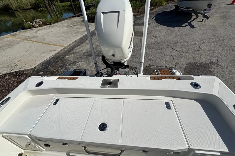 Slide: The Image of 2022 Ranger 2660 Bay boat with outboard motor, docked on a sunny day. - 9