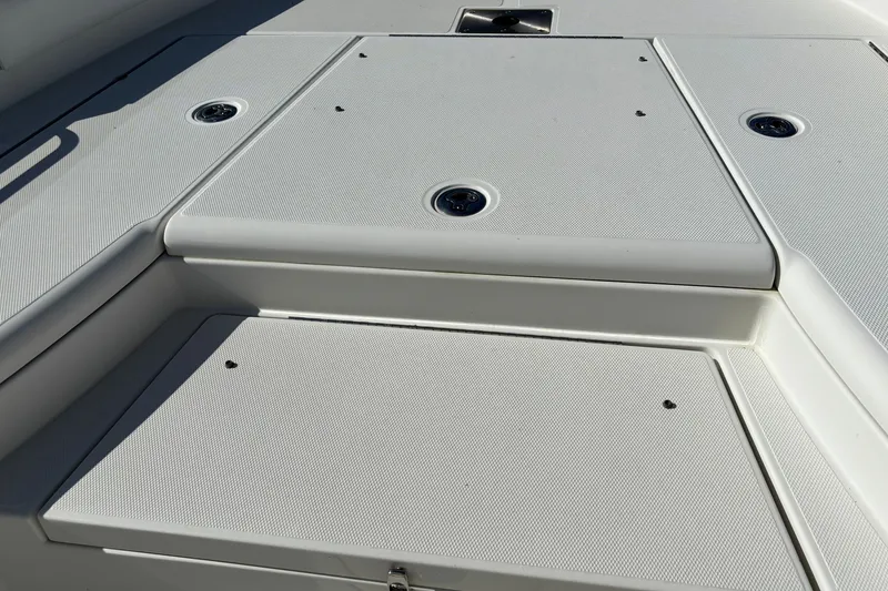 Slide: The Image of 2022 Ranger 2660 Bay boat deck with storage compartments and sleek design. - 6