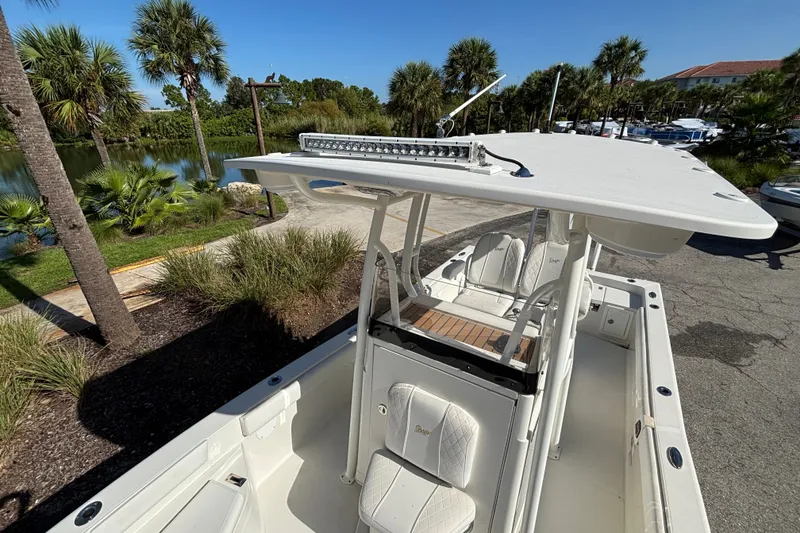 Slide: The Image of 2022 Ranger 2660 Bay boat with T-top, docked near palm trees. - 8