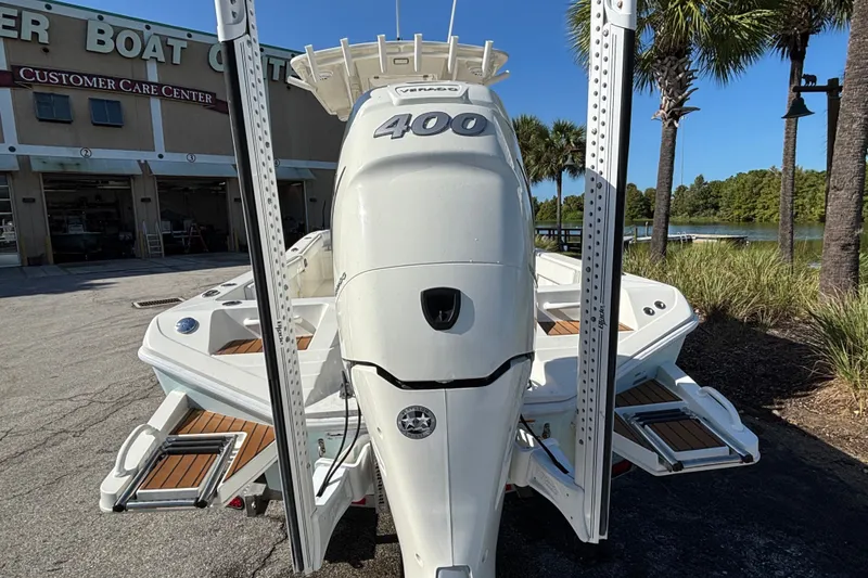 Slide: The Image of 2022 Ranger 2660 Bay boat with powerful engine, parked near a customer care center. - 4