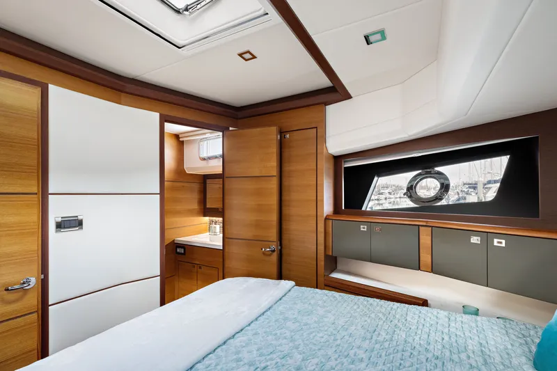 Slide: The Image of Luxurious interior of 2024 North Pacific 450 Pilothouse yacht cabin with modern wood finishes. - 14