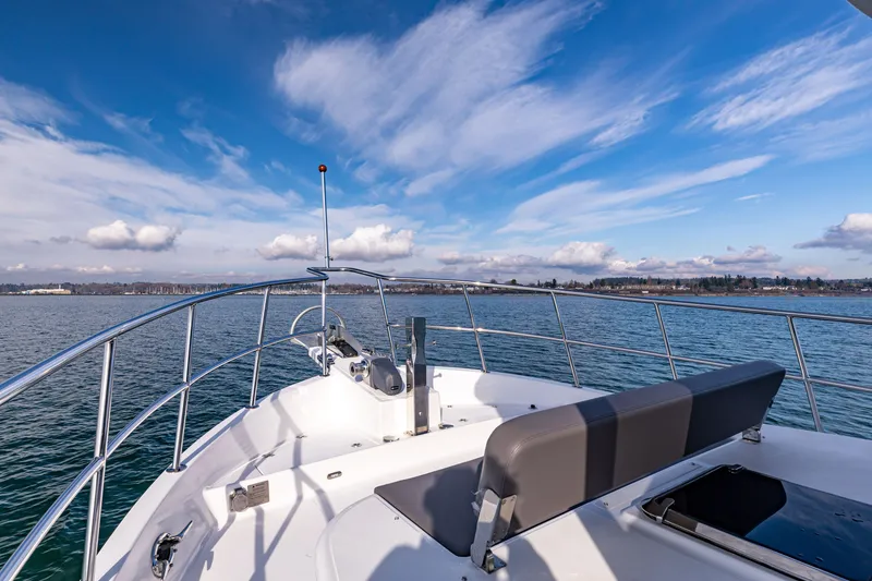 Slide: The Image of 2024 North Pacific 450 Pilothouse yacht deck with ocean view and blue sky. - 22
