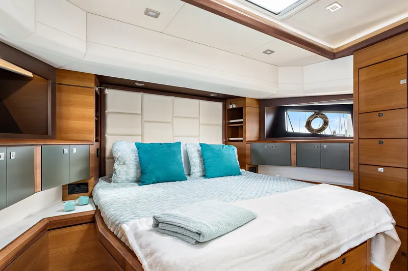 Slide: The Image of Luxurious bedroom interior of 2024 North Pacific 450 Pilothouse yacht with modern wood finishes. - 12