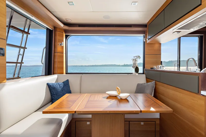 Slide: The Image of Luxurious interior of 2024 North Pacific 450 Pilothouse with ocean view and elegant dining area. - 8