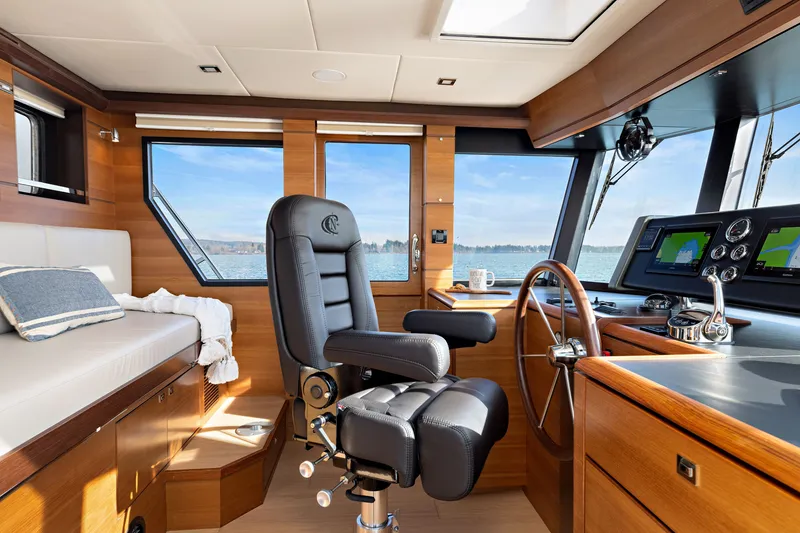 Slide: The Image of Luxurious interior of 2024 North Pacific 450 Pilothouse with modern helm and seating. - 10