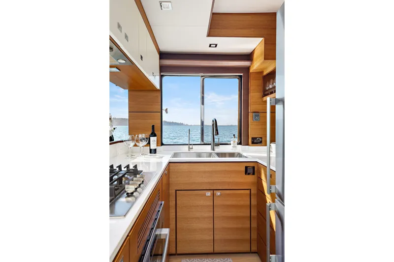 Slide: The Image of Luxurious kitchen interior of 2024 North Pacific 450 Pilothouse yacht with ocean view. - 16