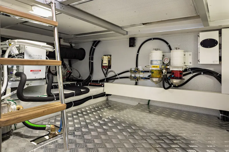 Slide: The Image of Engine room of 2024 North Pacific 450 Pilothouse with modern equipment and metal flooring. - 26