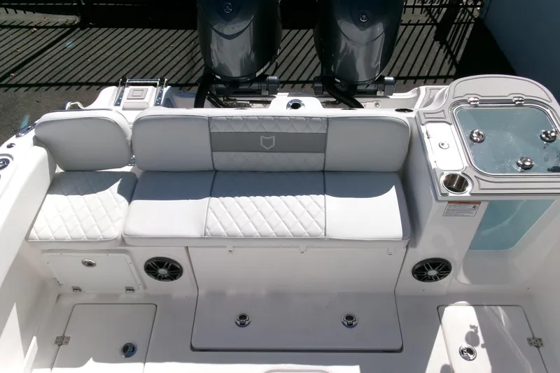 Slide: The Image of 2026 Sea Fox 268 Commander boat interior with cushioned seating and dual outboard motors. - 23