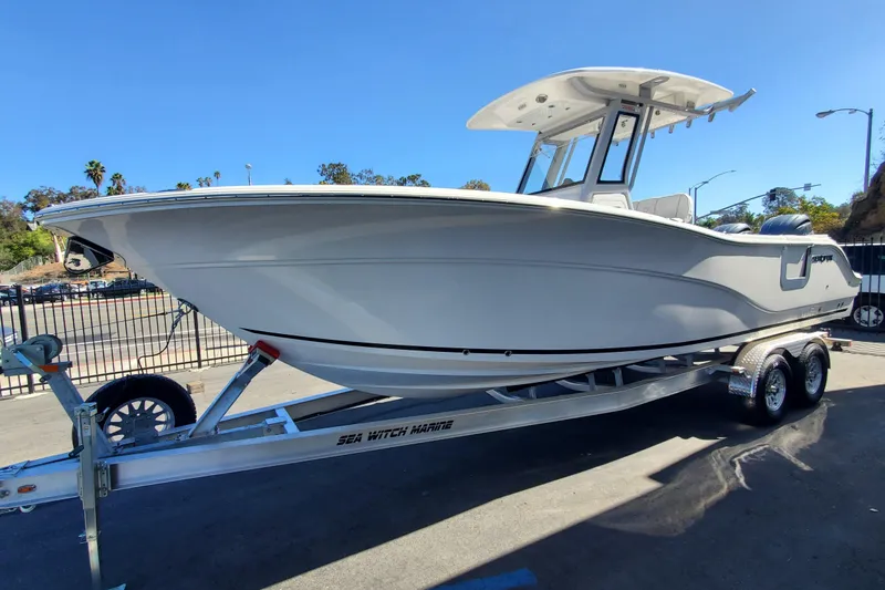 Slide: The Image of 2026 Sea Fox 268 Commander boat on trailer, parked outdoors under clear blue sky. - 1