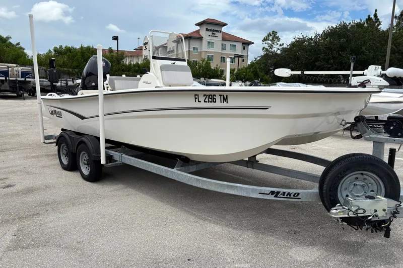 The Image of 2023 Mako Pro Skiff 19 CC boat on trailer in parking lot. - 0