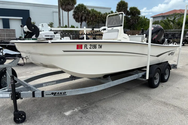 Slide: The Image of 2023 Mako Pro Skiff 19 CC boat on trailer, parked outdoors. - 2