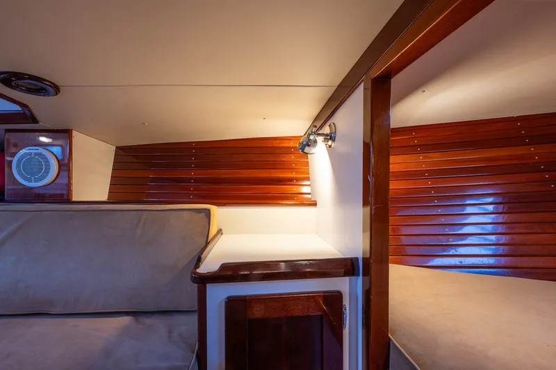 Slide: The Image of Interior of a 2005 Morris M36 yacht with wooden paneling and cozy seating. - 24