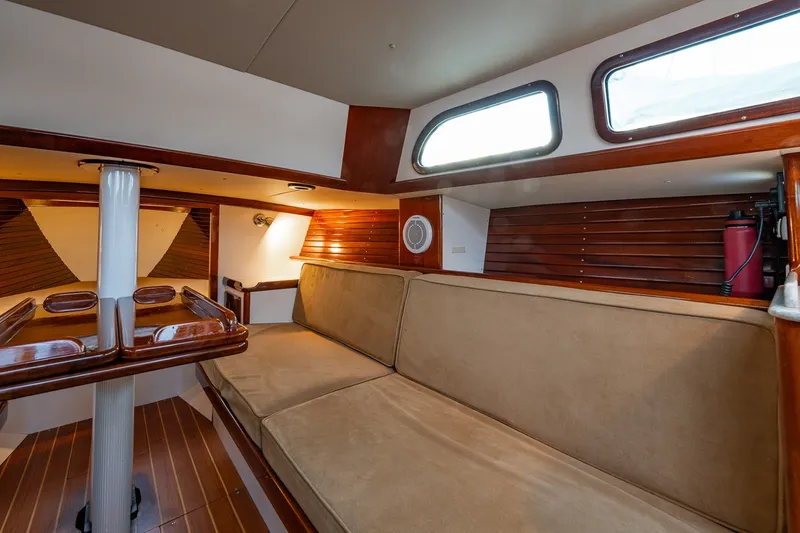 Slide: The Image of Interior of a 2005 Morris M36 sailboat with cozy seating and wooden accents. - 18