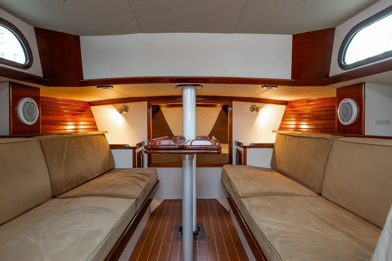 Slide: The Image of Luxurious interior of a 2005 Morris M36 yacht with elegant wood finishes and cozy seating. - 16