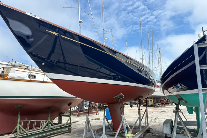 Slide: The Image of Morris M36 sailboat from 2005 in a boatyard, showcasing sleek design and vibrant colors. - 27