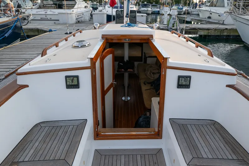 Slide: The Image of Morris M36 sailboat interior view at dock, showcasing wooden details and seating, 2005 model. - 14