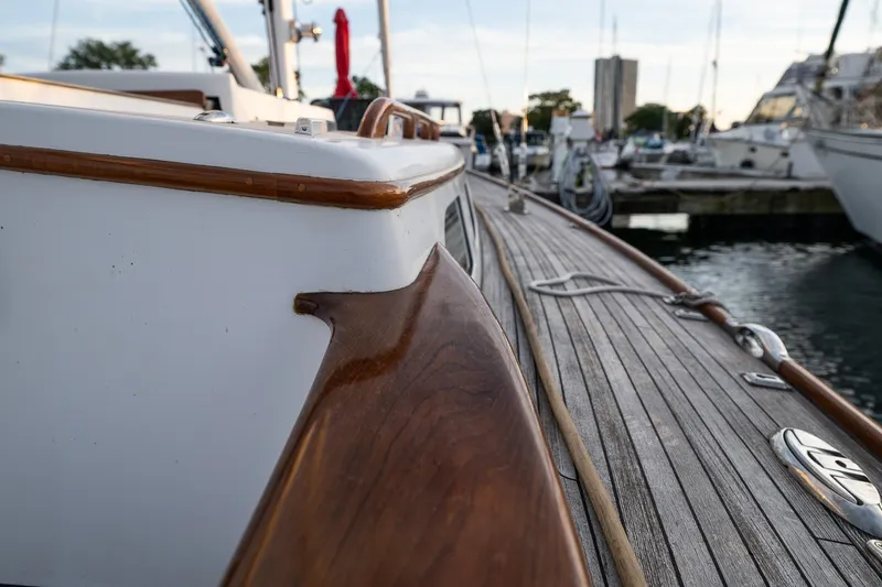 Slide: The Image of Close-up of a 2005 Morris M36 yacht deck with wooden details at a marina. - 13