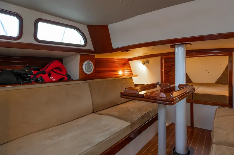 Slide: The Image of Interior of a 2005 Morris M36 sailboat with cozy seating and wooden accents. - 17
