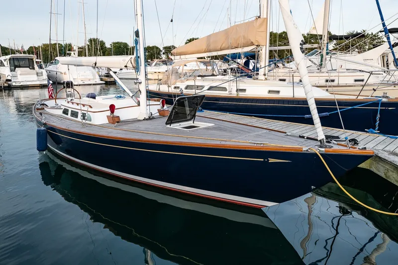 Slide: The Image of Sleek 2005 Morris M36 sailboat docked in a marina, showcasing elegant design and craftsmanship. - 1